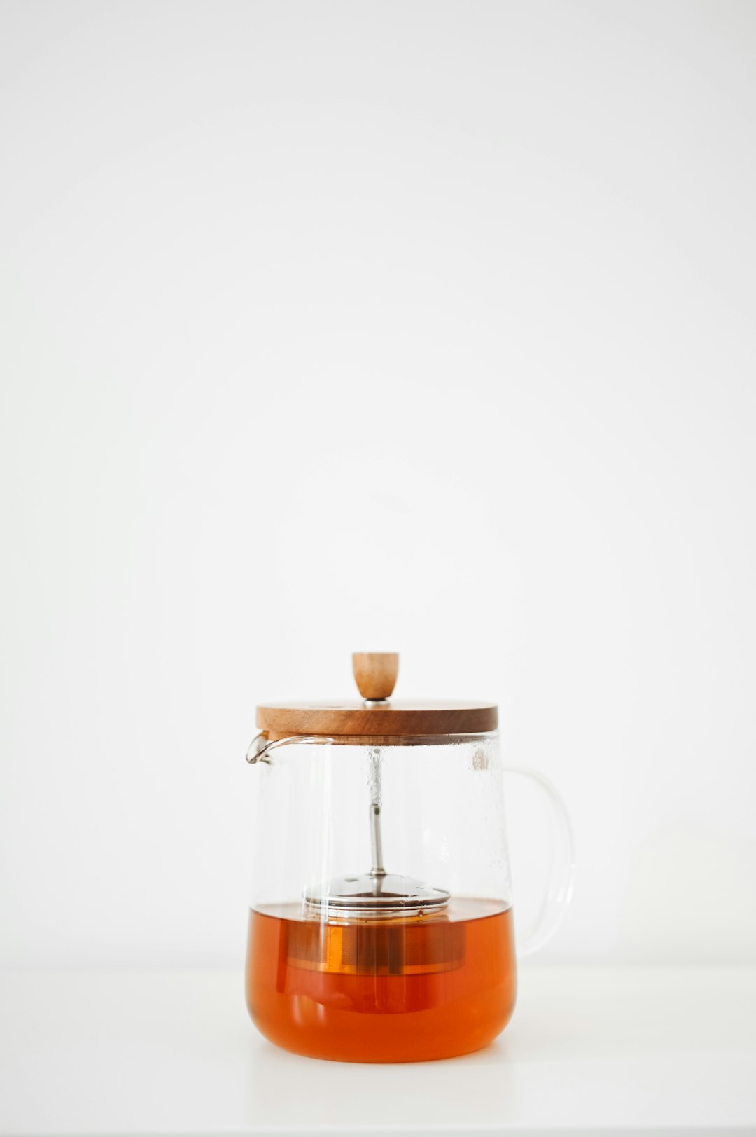 clear glass pitcher with brown liquid