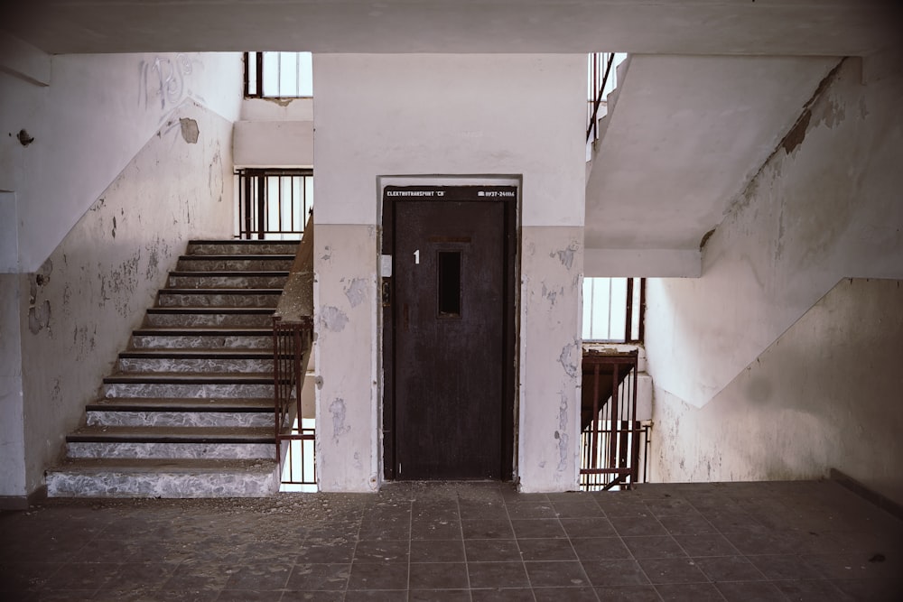 brown wooden door on white concrete wall