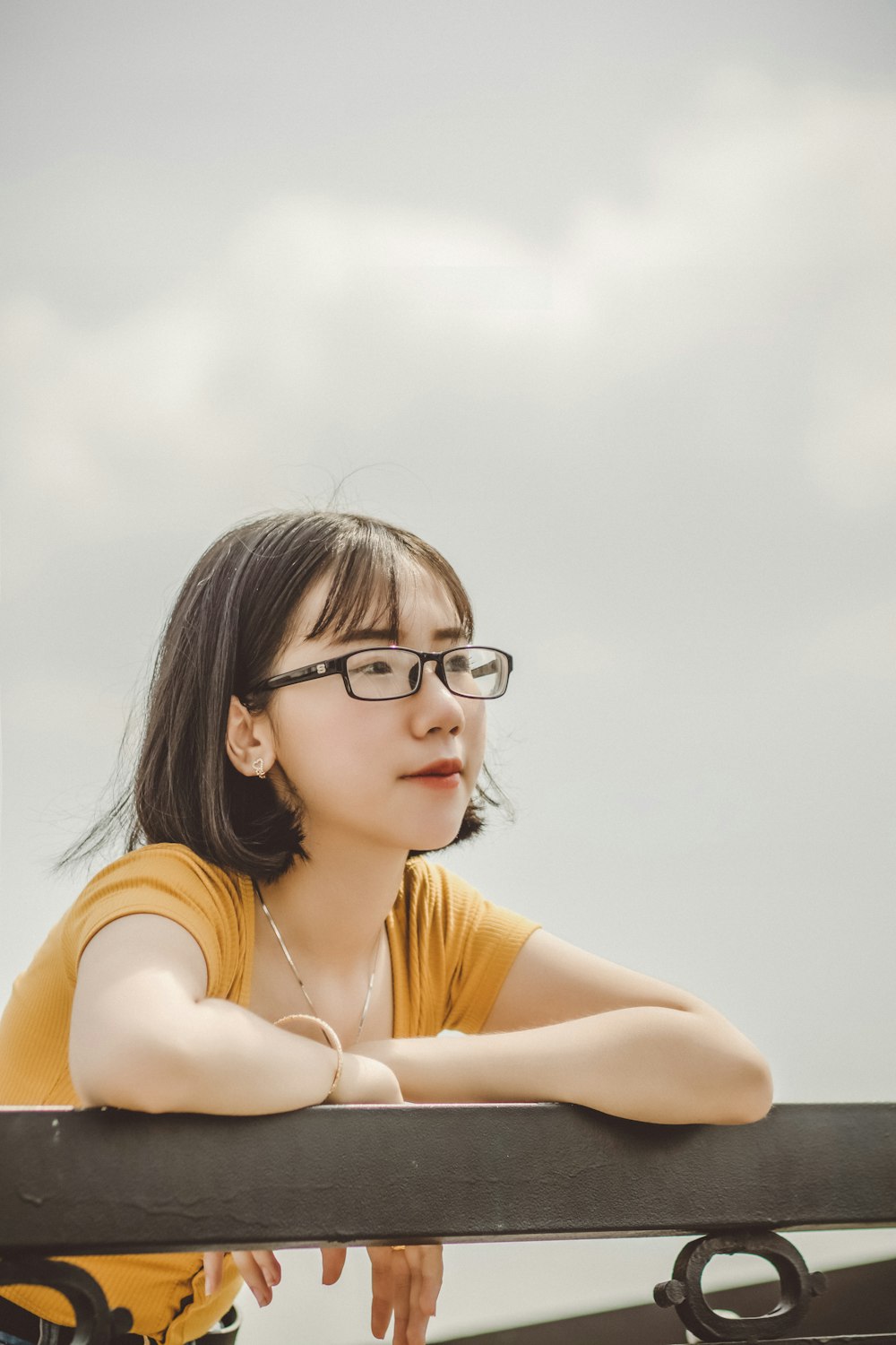 woman in black framed eyeglasses and yellow shirt