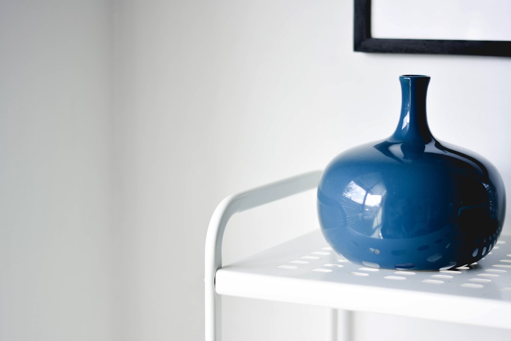 blue ceramic teapot on white plastic chair