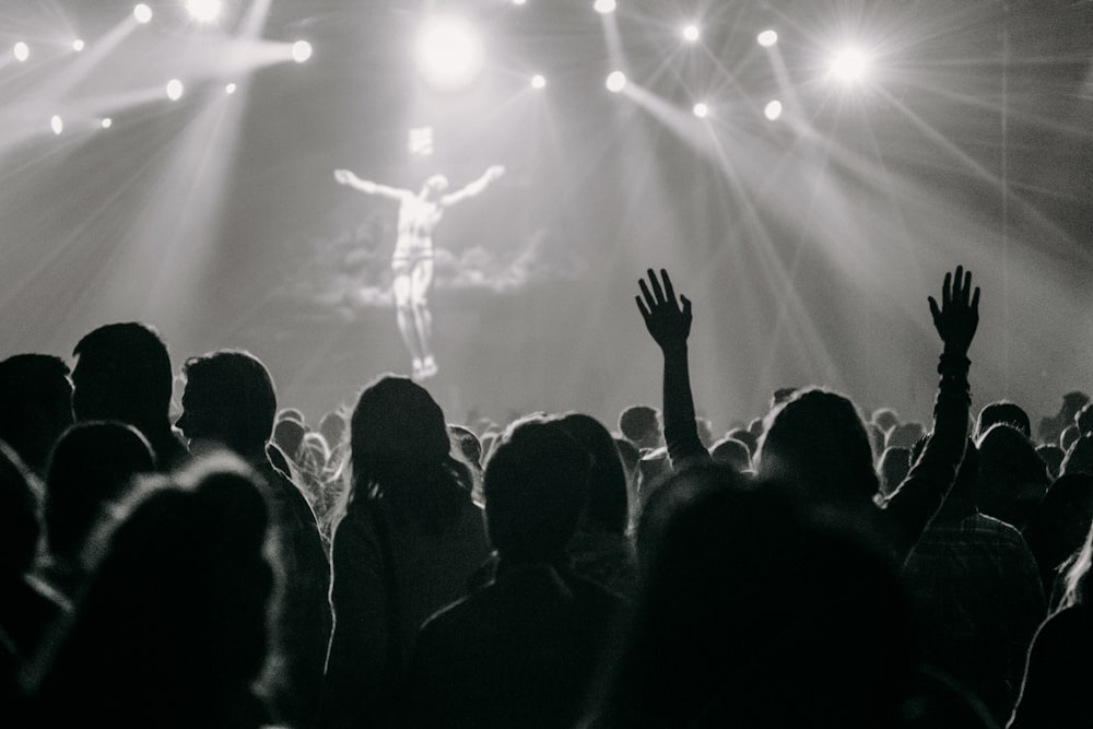 people raising their hands in front of people