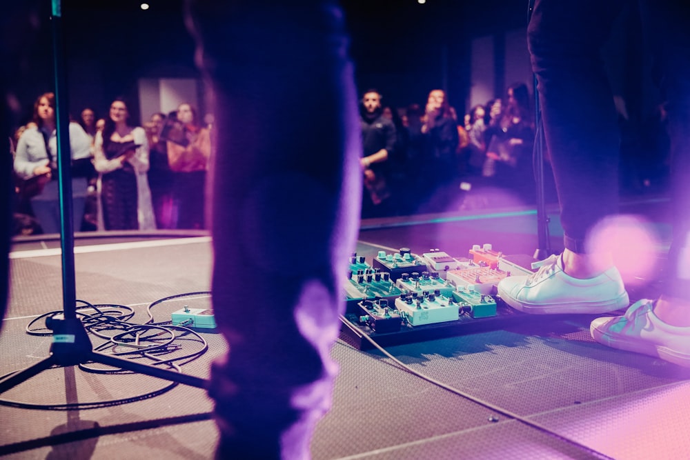 a person standing on a stage in front of a crowd