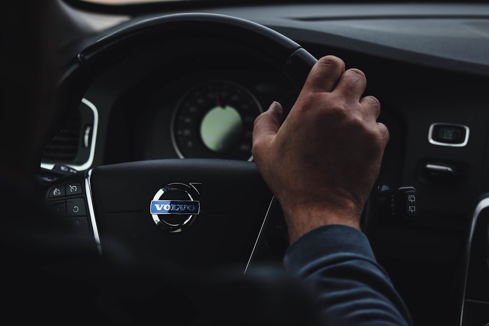 person in black long sleeve shirt driving car