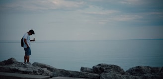 A scenic coastal view in Japan with a traveler browsing maps on their phone connected through esim japan.