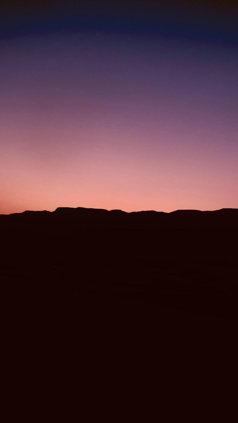 silhouette of mountain during sunset