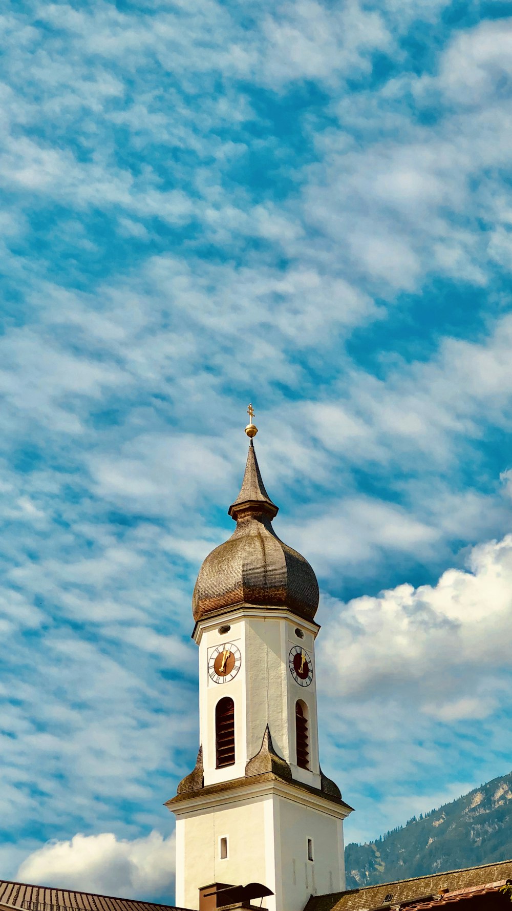 brown and white concrete building under blue sky