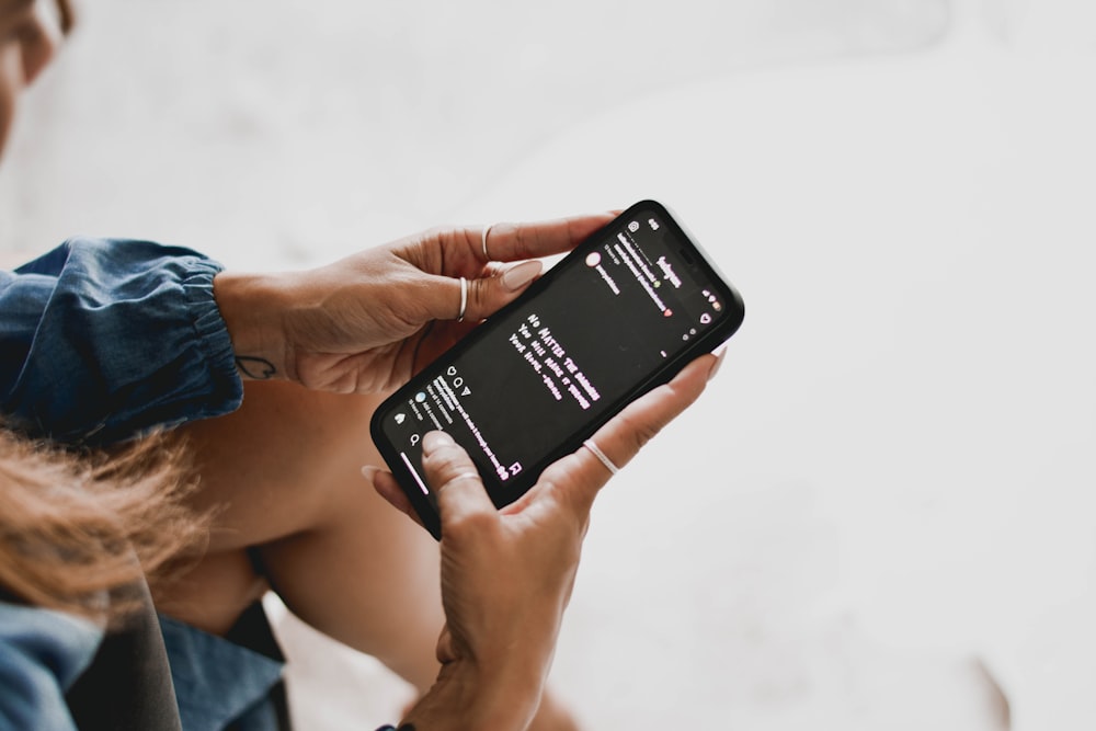 person holding black android smartphone