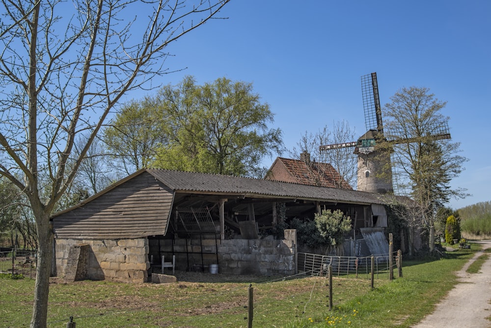 brown wooden house near bare trees under blue sky during daytime