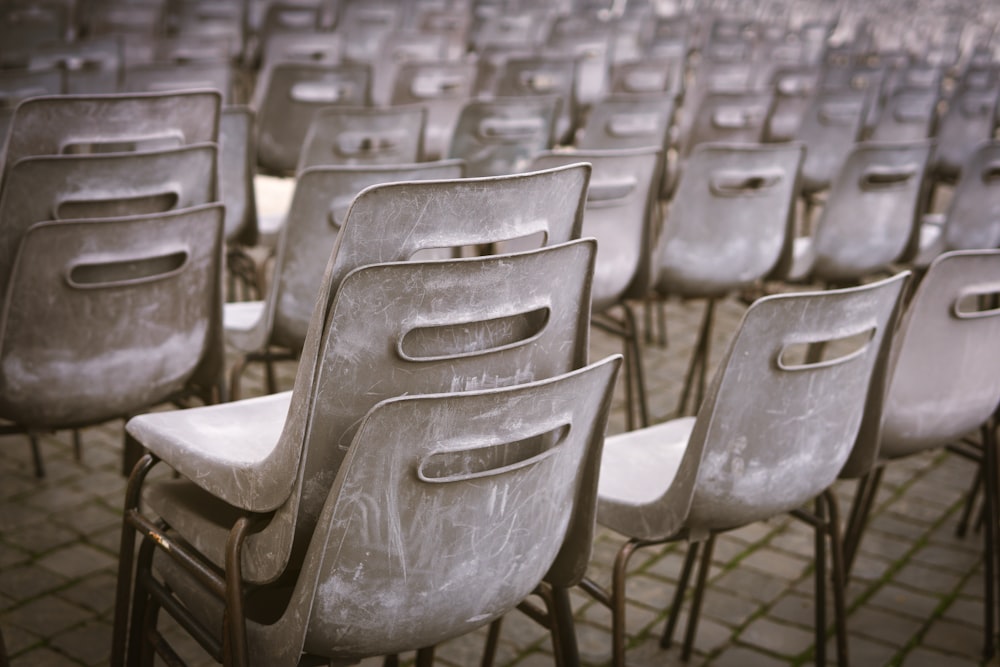 white plastic chairs on gray concrete floor