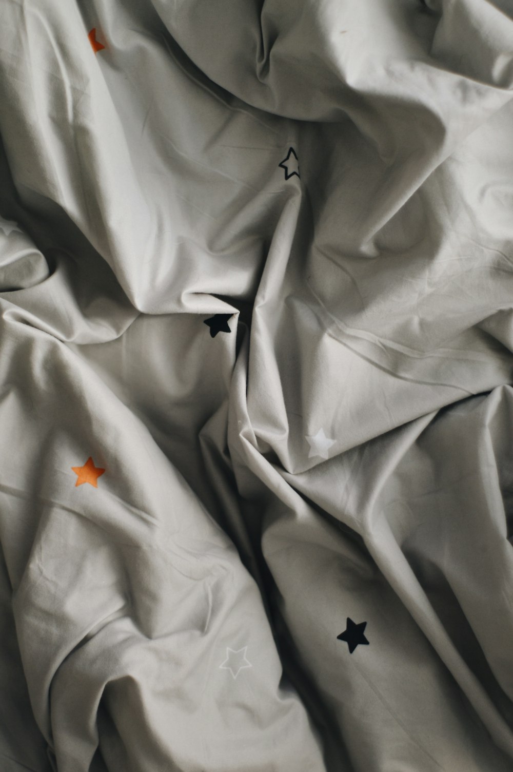 orange flower on white textile