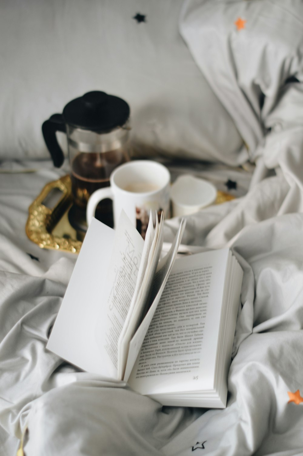 white ceramic mug on white textile