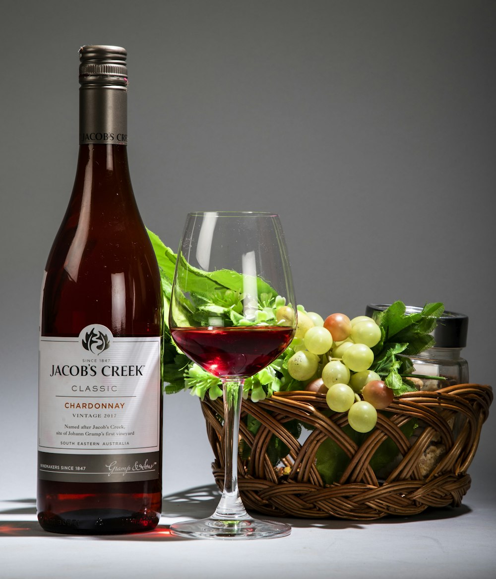 wine bottle beside wine glass on table