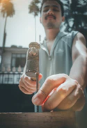 Close-up of hands hammering nails into timber during a build.