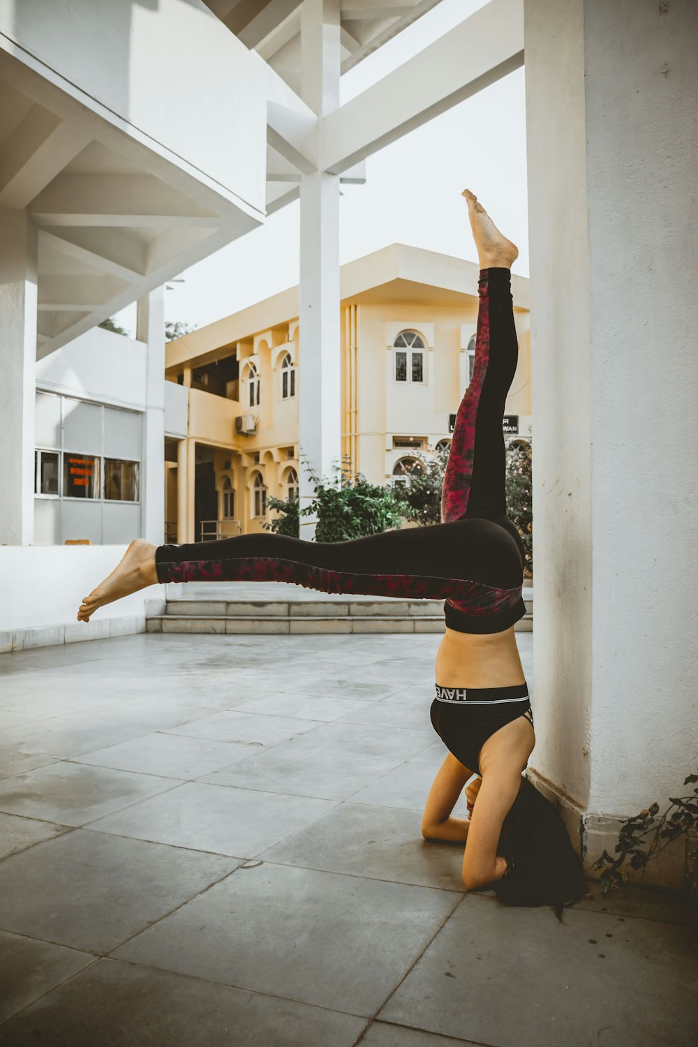 woman in black sports bra and black panty doing yoga