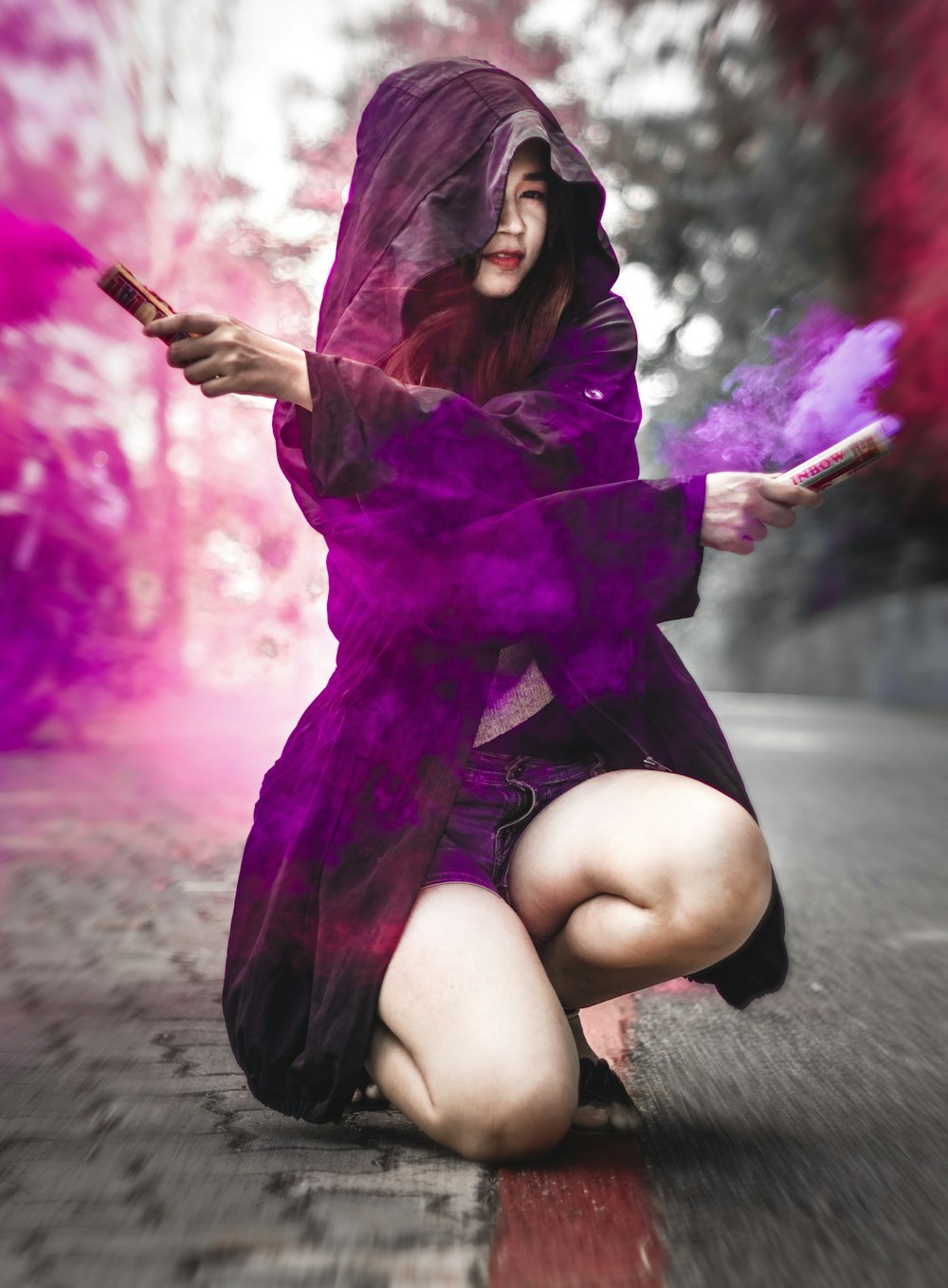 woman in purple dress sitting on gray concrete floor