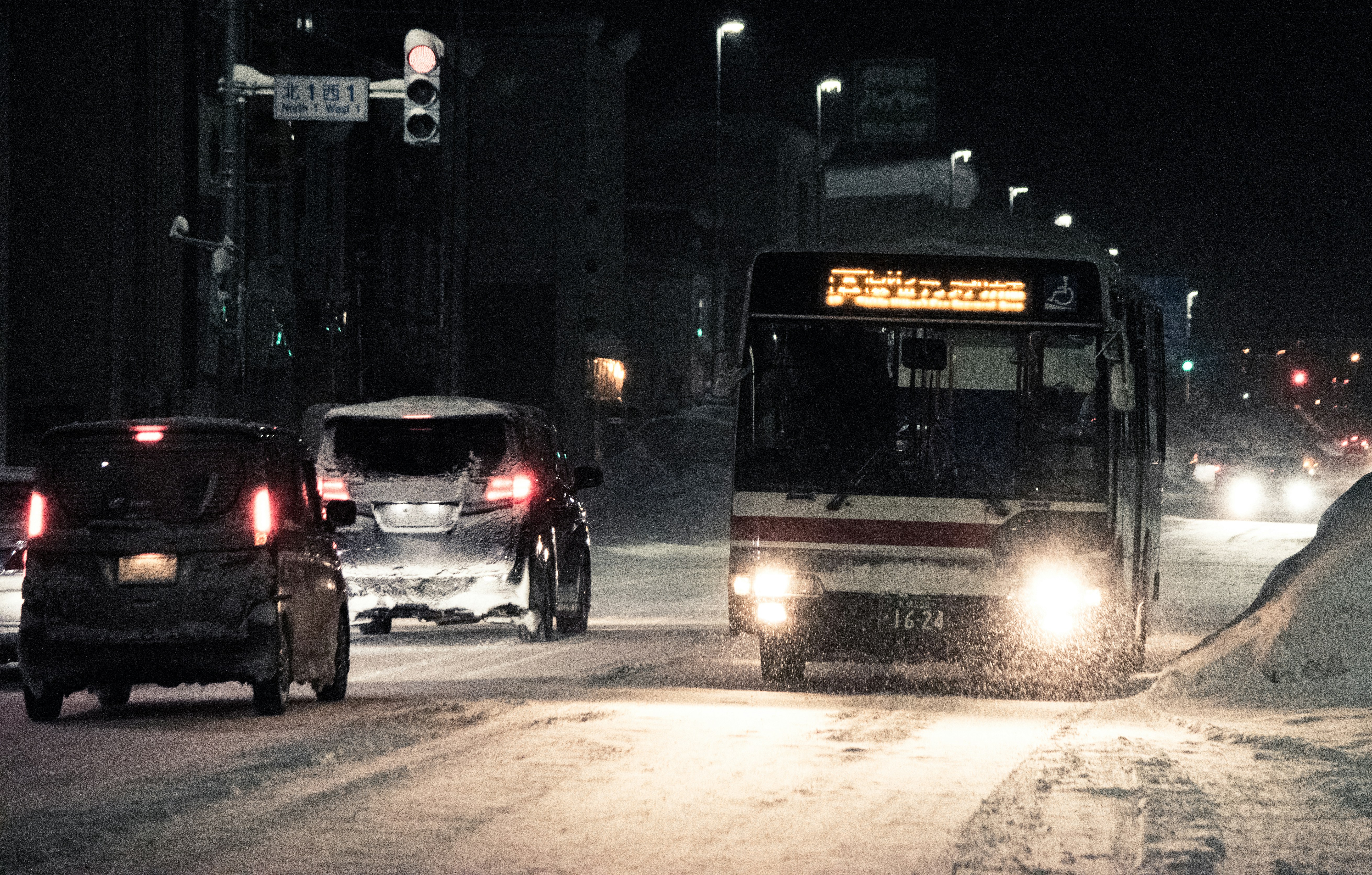 Midnight bus trip through snowy Niseko landscape