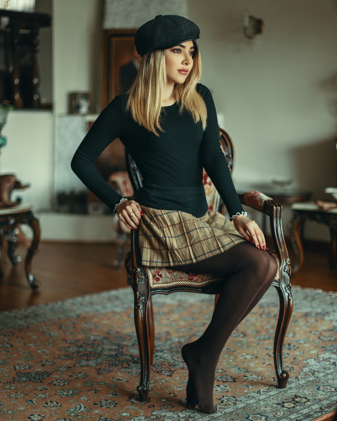 woman in black long sleeve shirt sitting on brown wooden chair