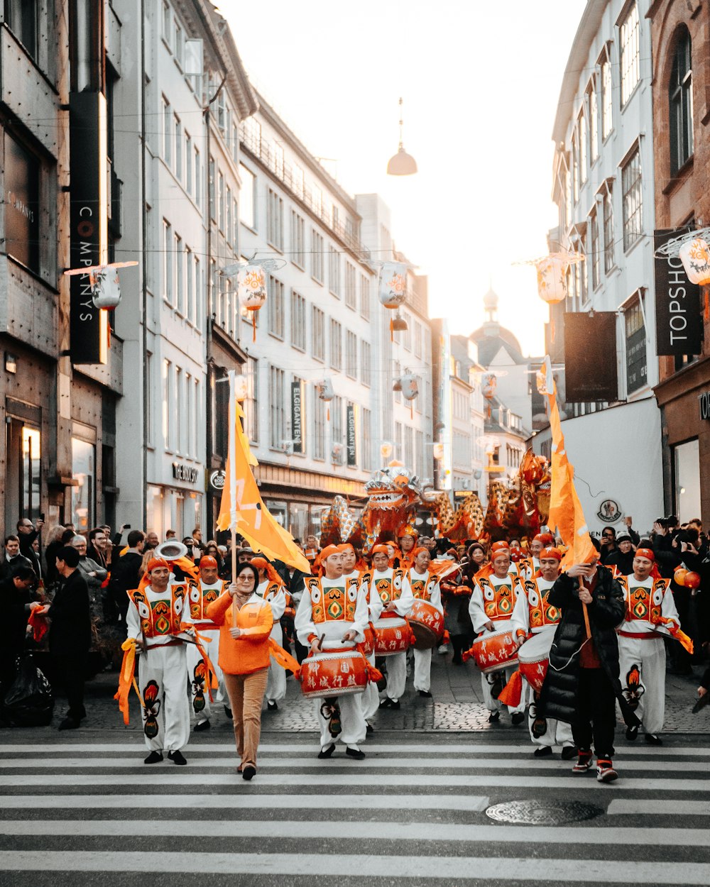 people in a street with people walking on a city with high rise buildings during daytime