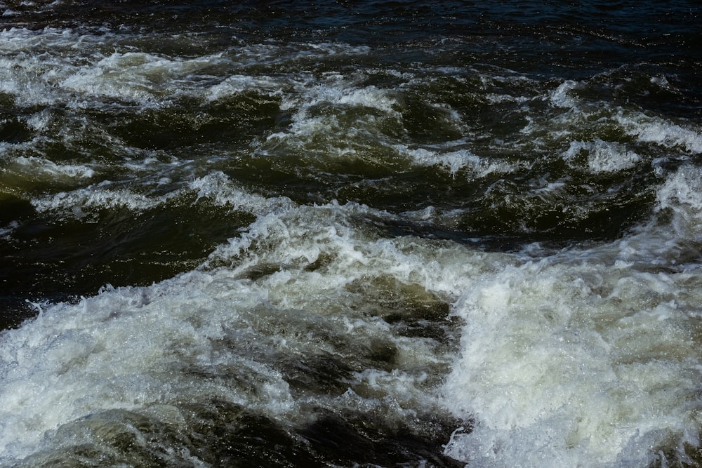 ocean waves crashing on shore during daytime