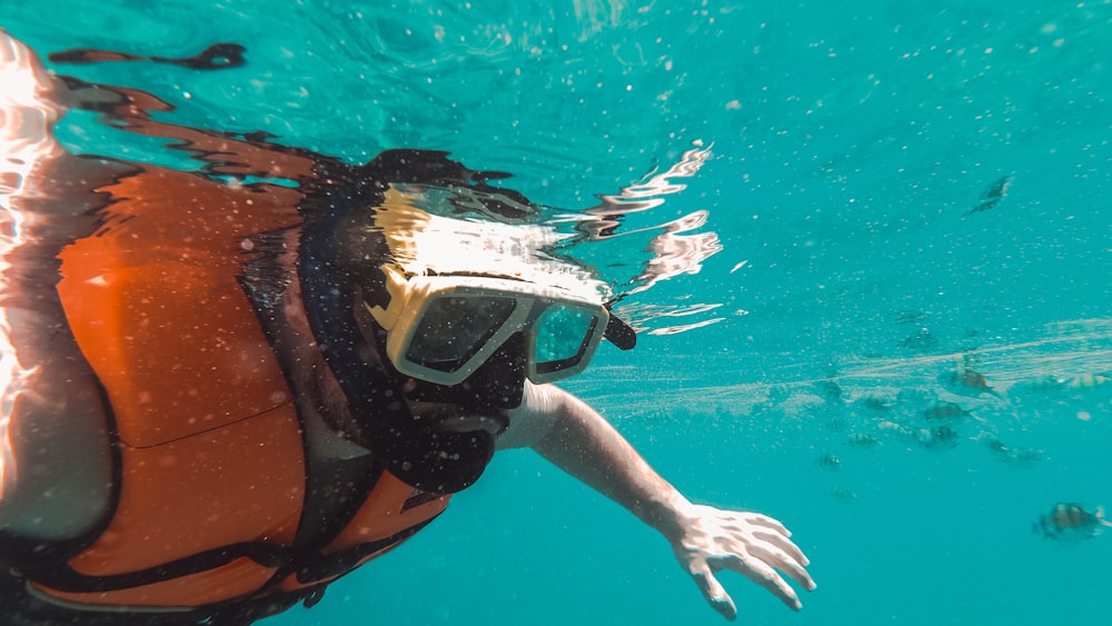 woman in orange and black bikini in water