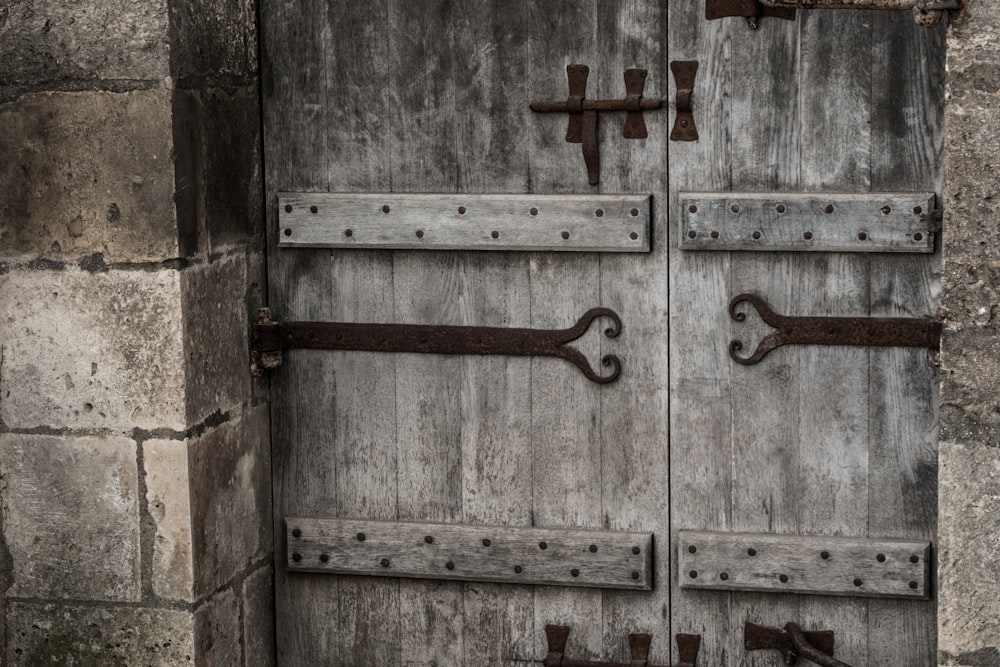 brown wooden door with cross