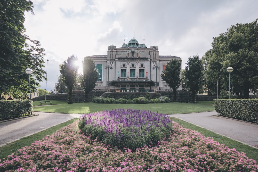 a large building with a garden in front of it