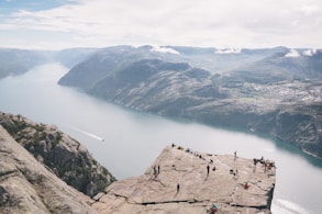 people standing on rocky mountain during daytime