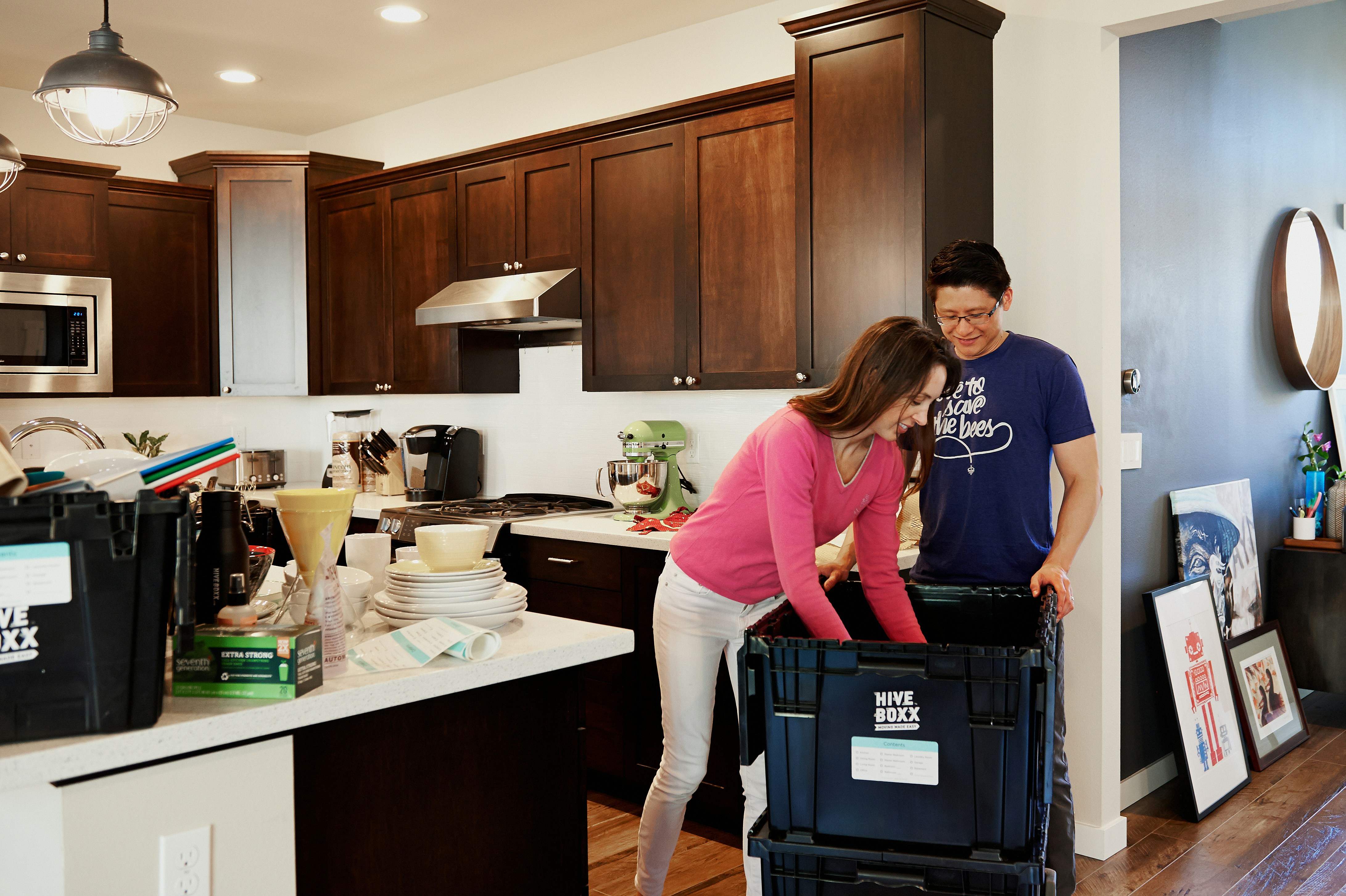 A person sitting at a tidy kitchen counter using a tablet to organize their weekly meals and budget for a solo household.