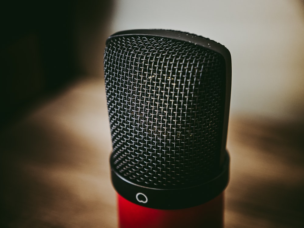 black and red microphone on brown wooden table