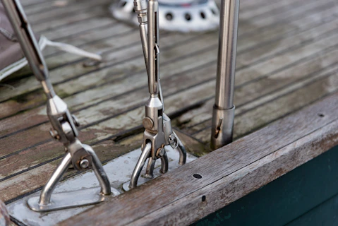 silver bicycle chain on brown wooden surface