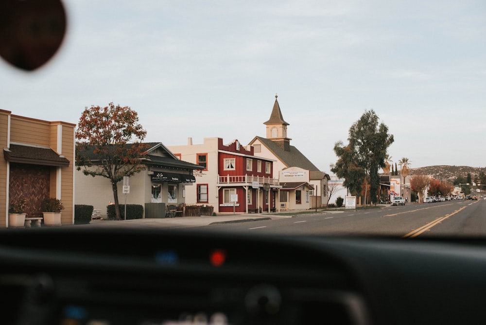 car on road near houses during daytime