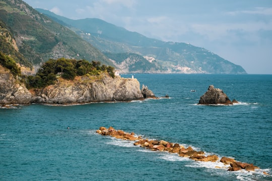 brown rock formation on blue sea during daytime in Parco Nazionale delle Cinque Terre Italy