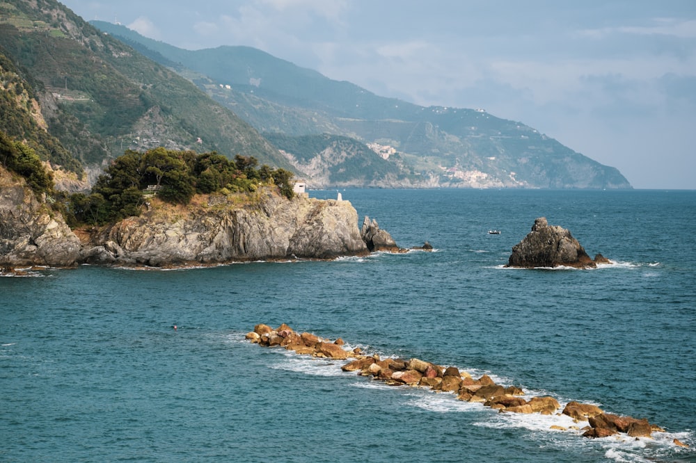 brown rock formation on blue sea during daytime