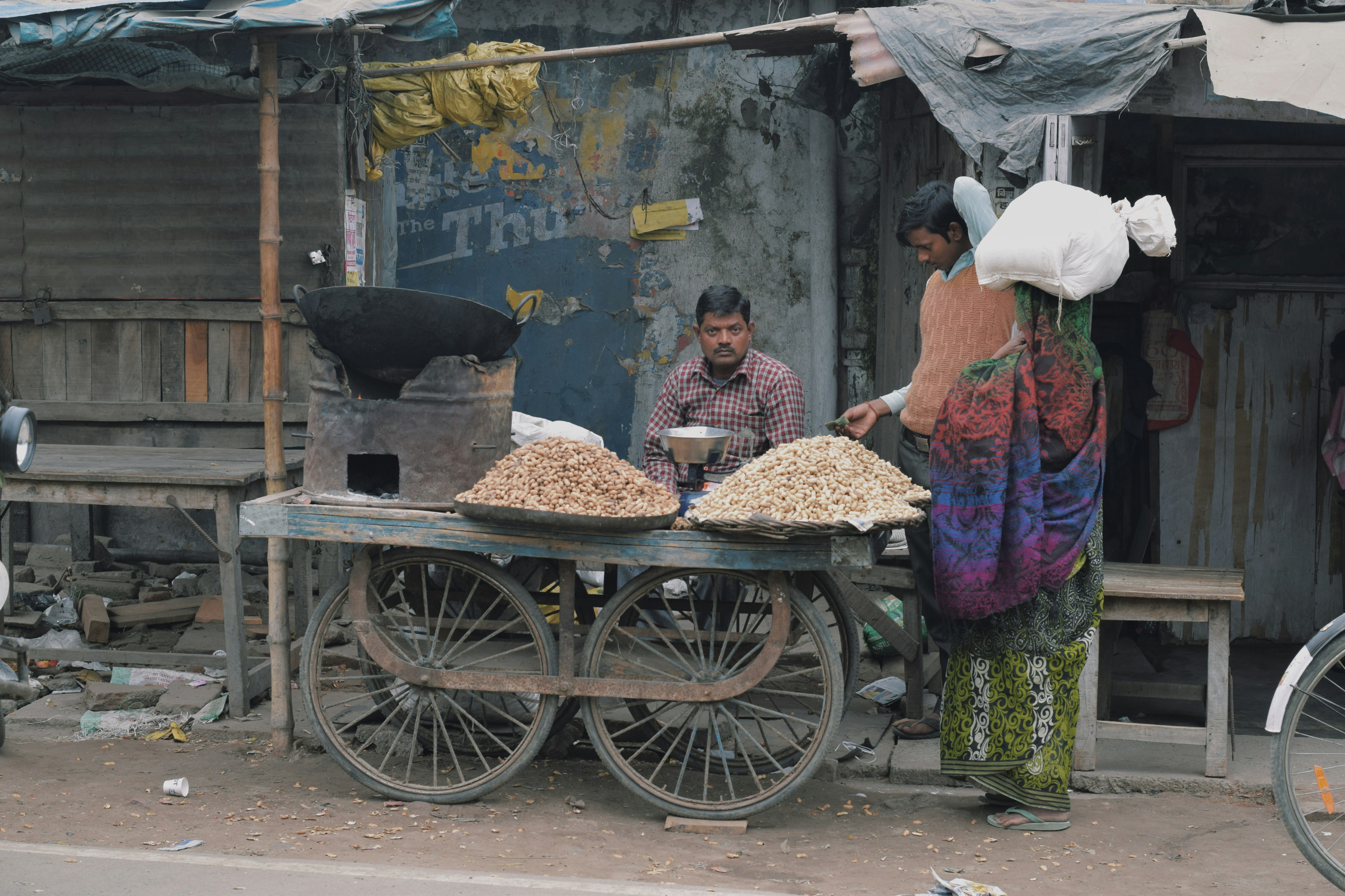 Indian shopkeeper using mobile for business