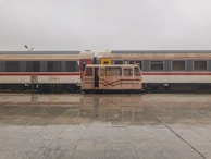 A TrustRide vehicle waiting patiently at a train station, ready for pickup.