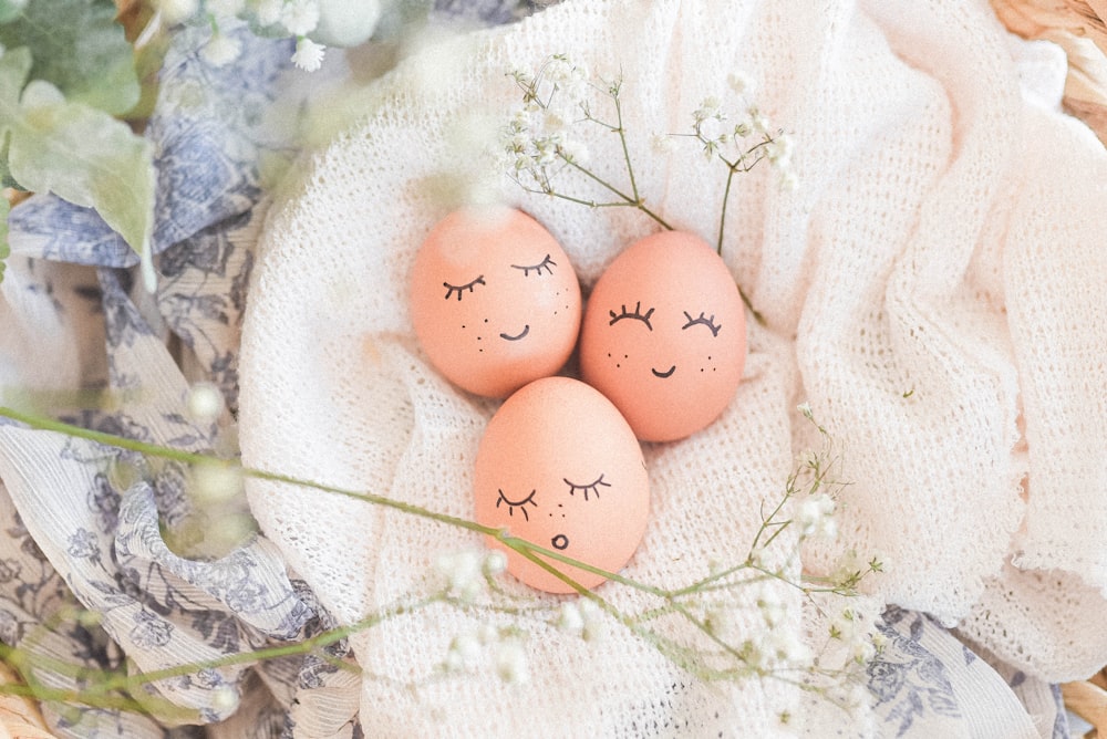 3 brown eggs on white textile