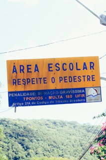a yellow sign hanging from the side of a road