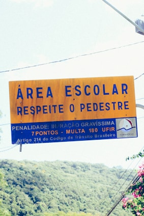 a yellow sign hanging from the side of a road