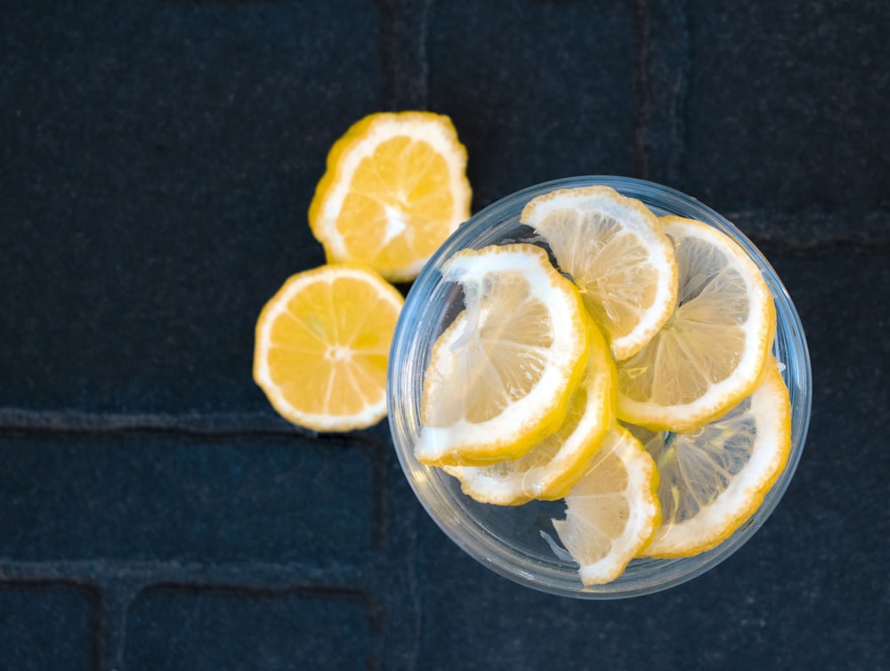 sliced lemon on clear glass bowl
