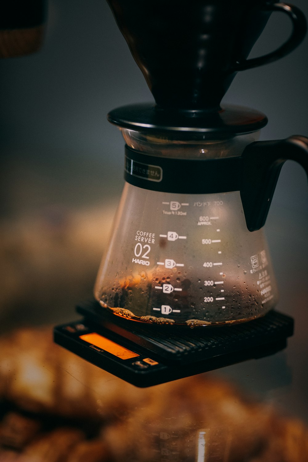 black coffee maker on brown wooden table