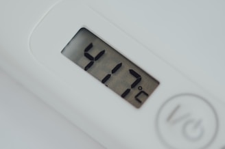 A close-up of a digital temperature sensor displaying data on a screen.