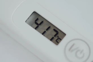 Close-up of a digital kitchen thermometer measuring meat temperature.