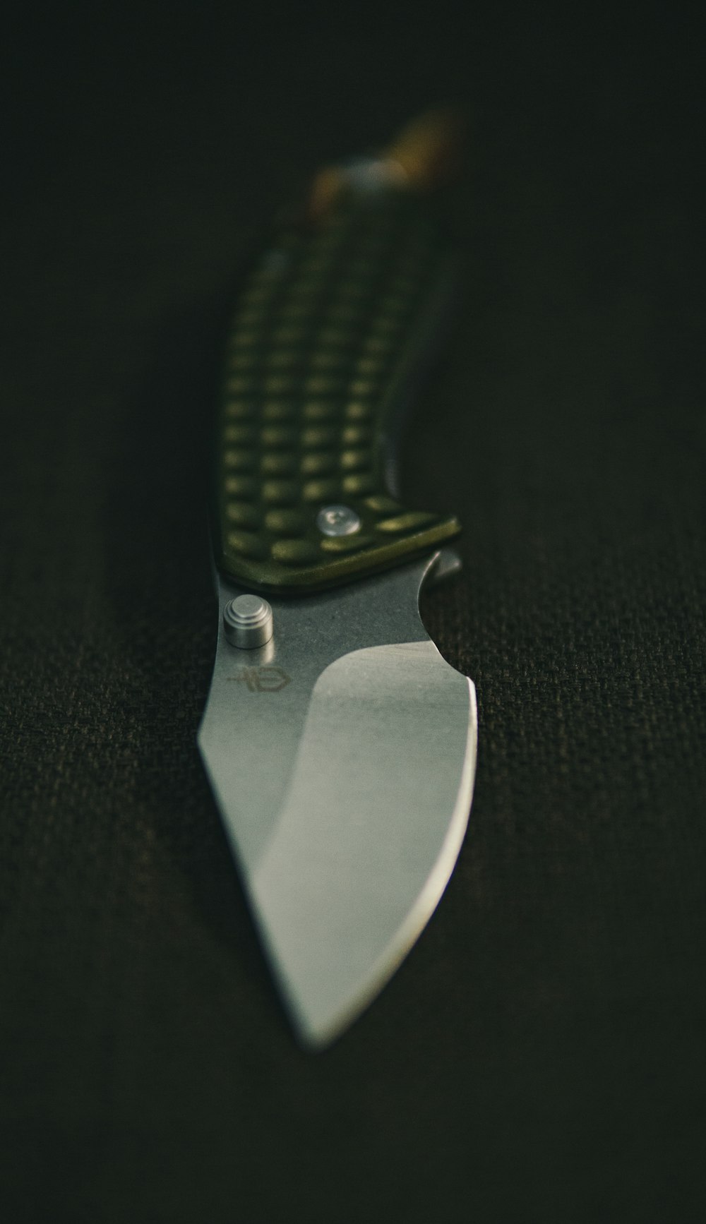 silver pocket knife on black textile