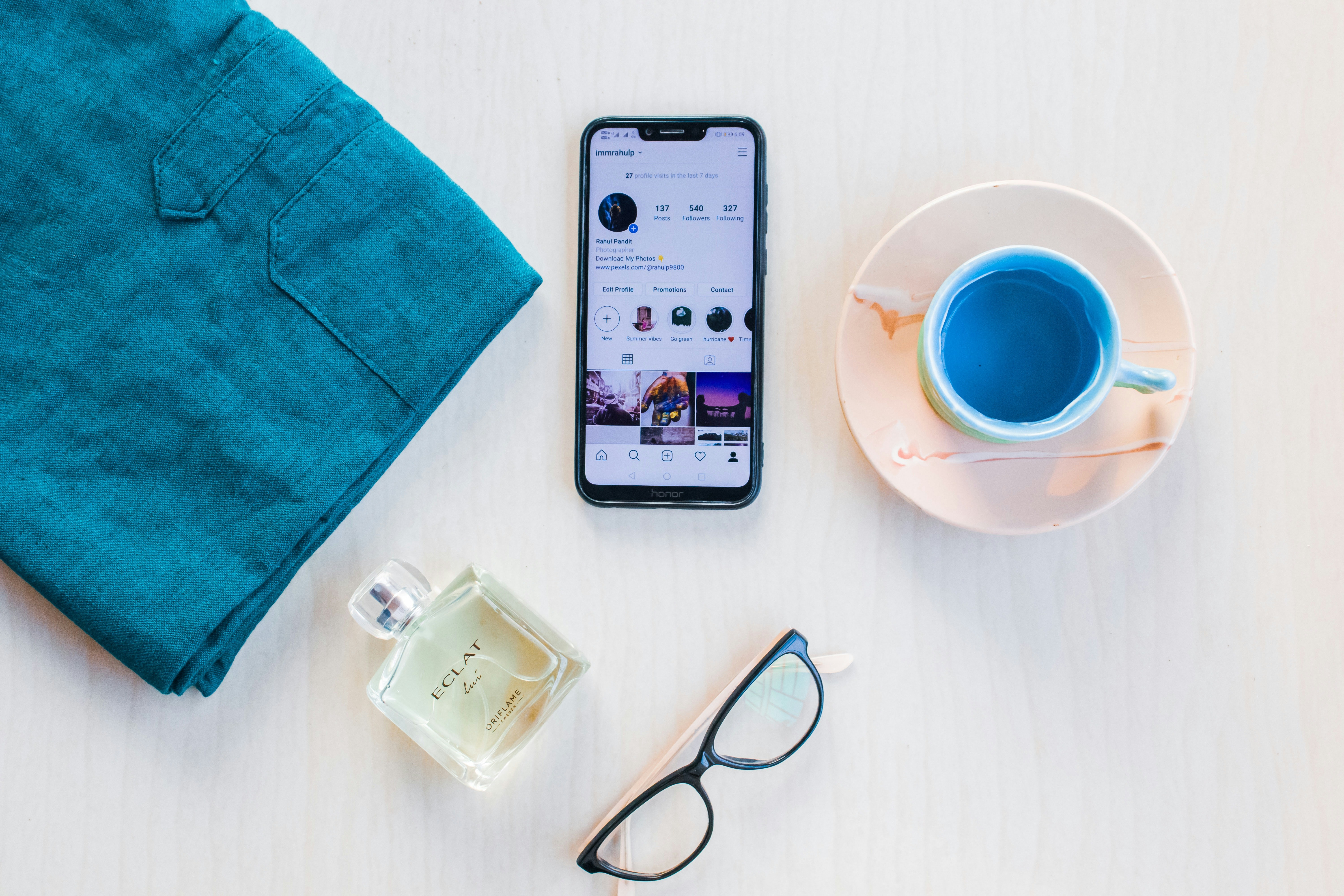 silver iphone 6 beside white ceramic mug on white table