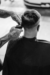 man in black crew neck shirt holding hair blower