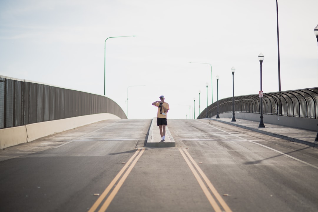 woman in black jacket and black pants running on gray concrete road during daytime