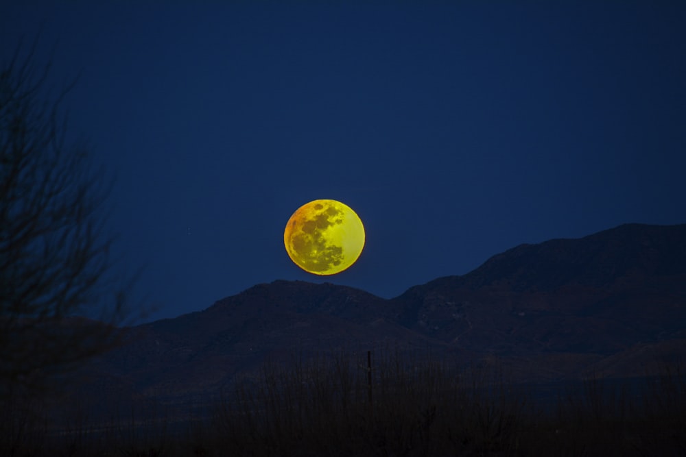 silhouette of mountain during night time