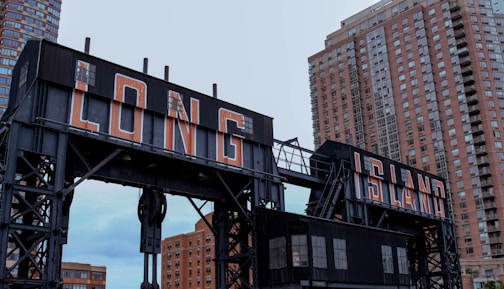 black and red metal crane near high rise buildings during daytime