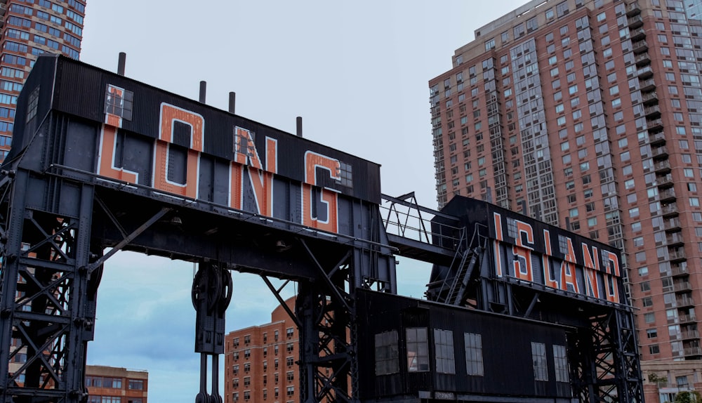 black and red metal crane near high rise buildings during daytime