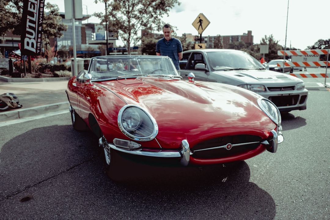 red convertible car on road during daytime